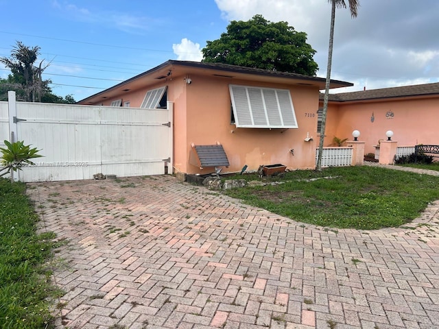 7110 SW 11th St, Pembroke Pines, FL 33023 - view of front facade with stucco siding and a patio area