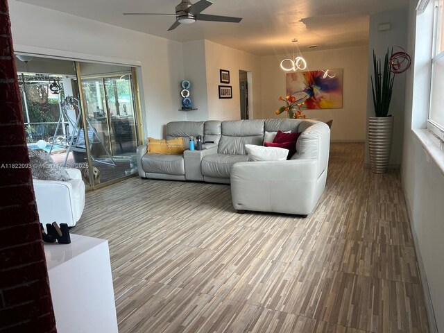 7110 SW 11th St, Pembroke Pines, FL 33023 - living room featuring ceiling fan, a chandelier, and wood finished floors