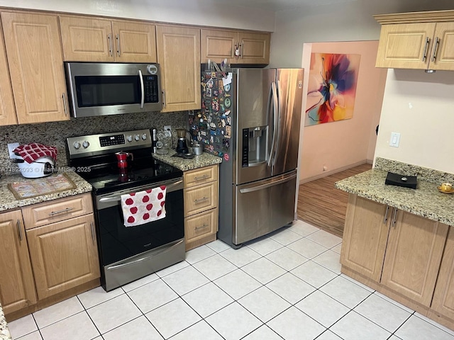 7110 SW 11th St, Pembroke Pines, FL 33023 - kitchen with stainless steel appliances, tasteful backsplash, light tile patterned floors, light stone counters, and light brown cabinetry