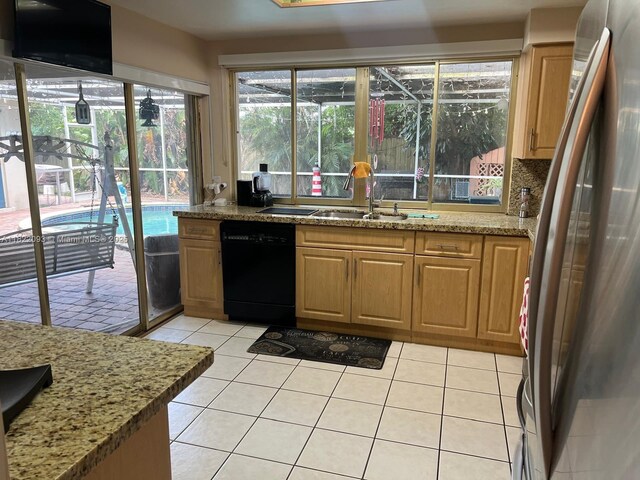 7110 SW 11th St, Pembroke Pines, FL 33023 - kitchen with black dishwasher, freestanding refrigerator, light stone counters, and light tile patterned floors