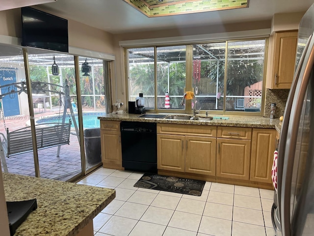 7110 SW 11th St, Pembroke Pines, FL 33023 - kitchen with black dishwasher, freestanding refrigerator, light tile patterned floors, and light stone countertops