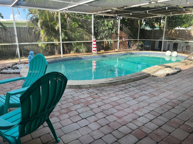 7110 SW 11th St, Pembroke Pines, FL 33023 - view of swimming pool with a fenced backyard, a lanai, and a patio