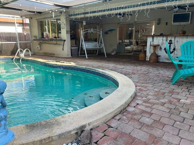 7110 SW 11th St, Pembroke Pines, FL 33023 - swimming pool with a patio, glass enclosure, and a ceiling fan