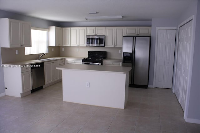 15270 SW 30th Ter, Miami, FL 33185 - kitchen featuring appliances with stainless steel finishes, light countertops, a kitchen island, and light tile patterned flooring