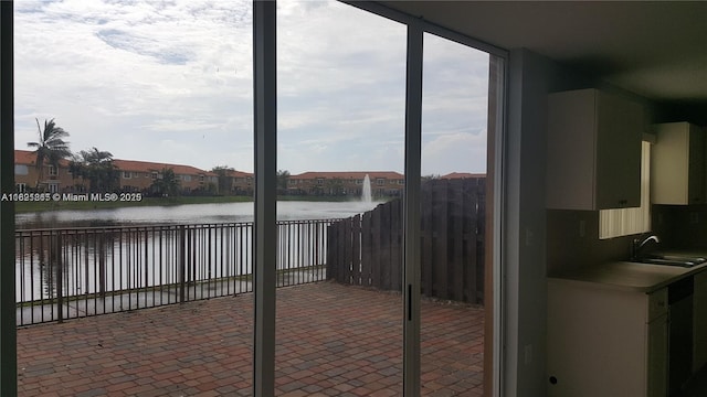 15270 SW 30th Ter, Miami, FL 33185 - unfurnished sunroom featuring a water view and a sink