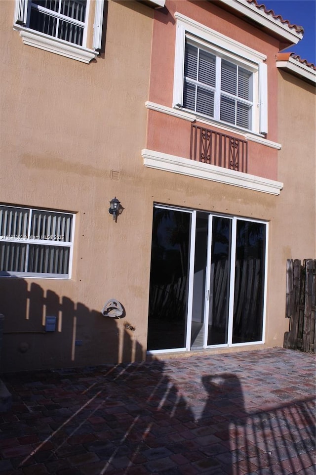 15270 SW 30th Ter, Miami, FL 33185 - rear view of property featuring a balcony, stucco siding, a patio area, and a tiled roof