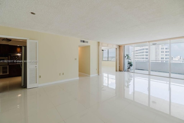 11 Island Ave Unit 1410, Miami Beach, FL 33139 - spare room with a textured ceiling, healthy amount of natural light, and light tile patterned floors