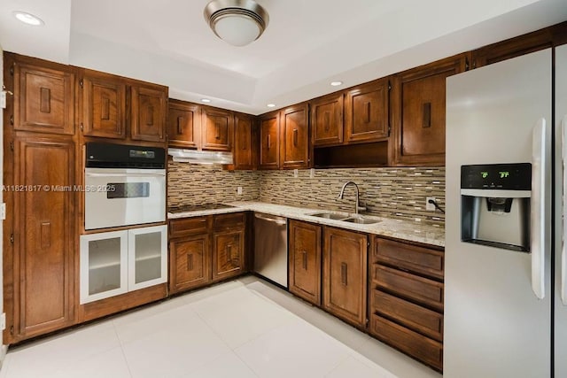 11 Island Ave Unit 1410, Miami Beach, FL 33139 - kitchen with fridge with ice dispenser, white oven, dishwasher, black electric cooktop, and under cabinet range hood