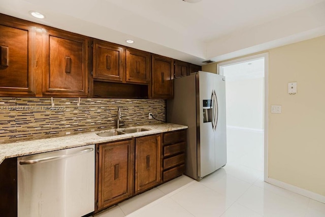 11 Island Ave Unit 1410, Miami Beach, FL 33139 - kitchen featuring appliances with stainless steel finishes, backsplash, light stone counters, recessed lighting, and light tile patterned floors