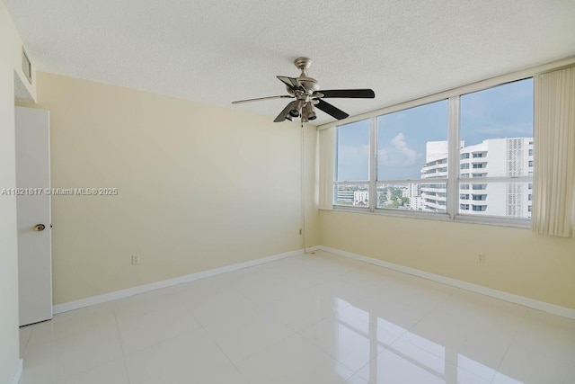 11 Island Ave Unit 1410, Miami Beach, FL 33139 - tiled spare room with ceiling fan and a textured ceiling