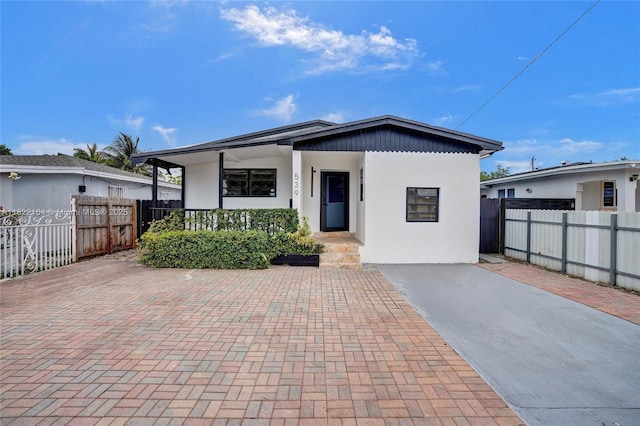539 E 30th St, Hialeah, FL 33013 - view of front facade featuring stucco siding and a porch