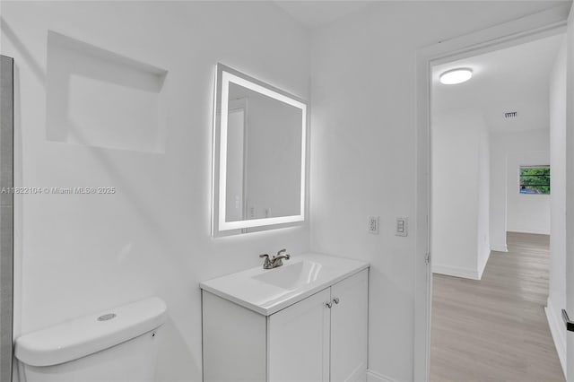 539 E 30th St, Hialeah, FL 33013 - bathroom with vanity and wood finished floors