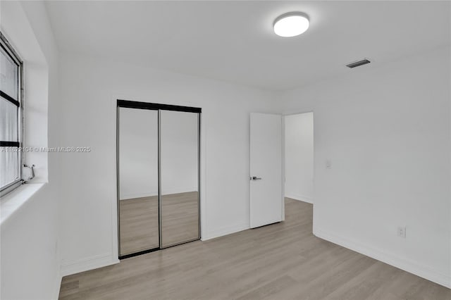 539 E 30th St, Hialeah, FL 33013 - unfurnished bedroom with wood finished floors and a closet