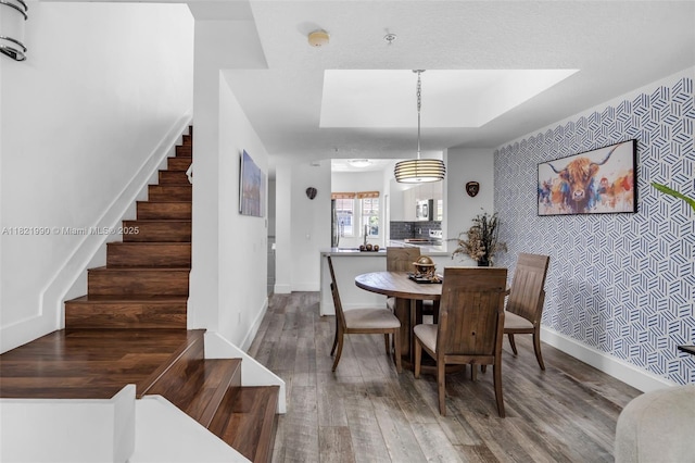 8940 NE 8th Ave Unit 1203, Miami, FL 33138 - dining area featuring wood finished floors, stairs, and an accent wall