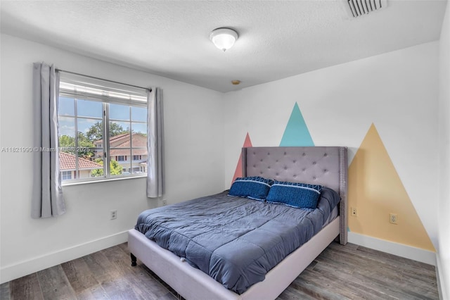 8940 NE 8th Ave Unit 1203, Miami, FL 33138 - bedroom with wood finished floors and a textured ceiling