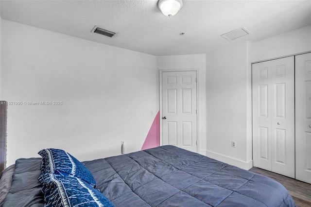 8940 NE 8th Ave Unit 1203, Miami, FL 33138 - bedroom with a textured ceiling, wood finished floors, and a closet