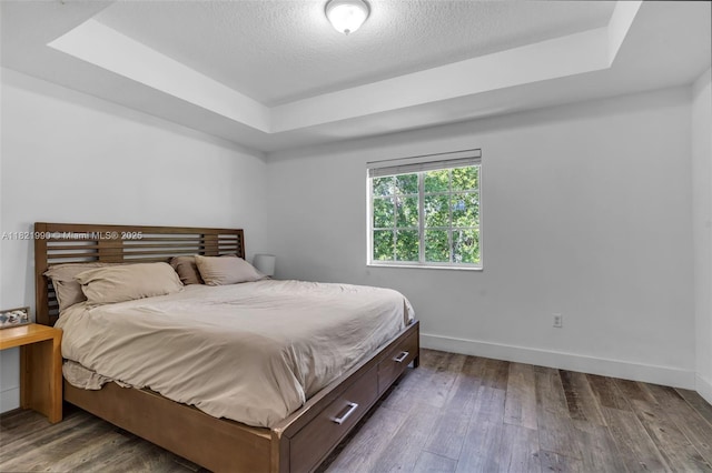 8940 NE 8th Ave Unit 1203, Miami, FL 33138 - bedroom featuring a raised ceiling, wood finished floors, and a textured ceiling