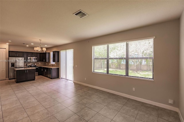 3809 Aspen Leaf Dr, Boynton Beach, FL 33436 - kitchen with stainless steel appliances, a chandelier, light countertops, light tile patterned floors, and recessed lighting