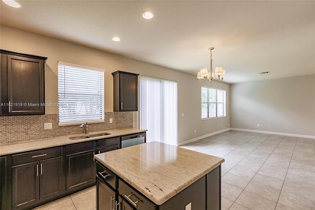 3809 Aspen Leaf Dr, Boynton Beach, FL 33436 - kitchen with tasteful backsplash, light tile patterned floors, a chandelier, stainless steel dishwasher, and light stone counters