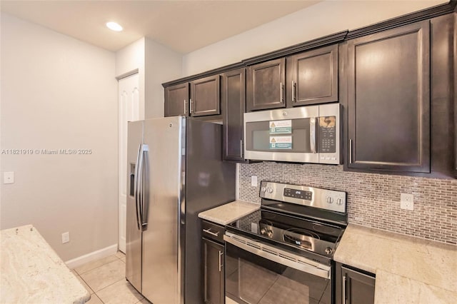 3809 Aspen Leaf Dr, Boynton Beach, FL 33436 - kitchen with stainless steel appliances, dark brown cabinets, decorative backsplash, and light tile patterned flooring