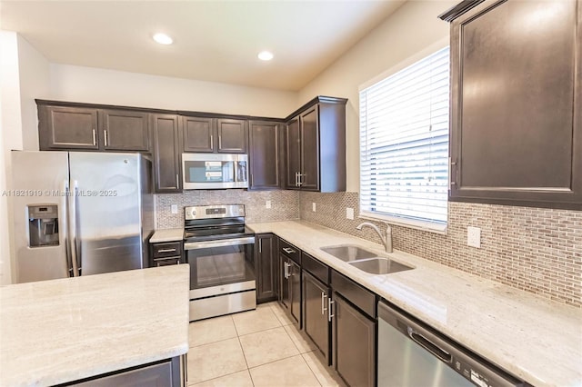 3809 Aspen Leaf Dr, Boynton Beach, FL 33436 - kitchen featuring stainless steel appliances, dark brown cabinetry, tasteful backsplash, and recessed lighting