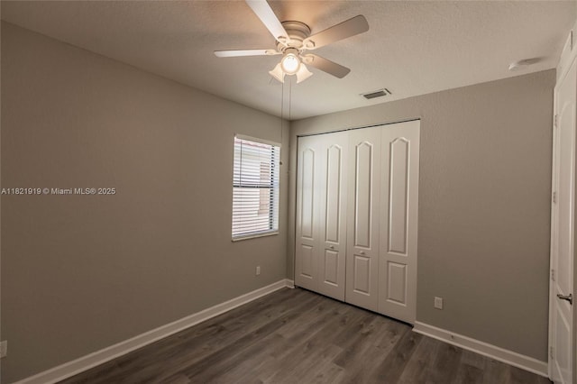 3809 Aspen Leaf Dr, Boynton Beach, FL 33436 - unfurnished bedroom with dark wood finished floors, a closet, a textured ceiling, and ceiling fan