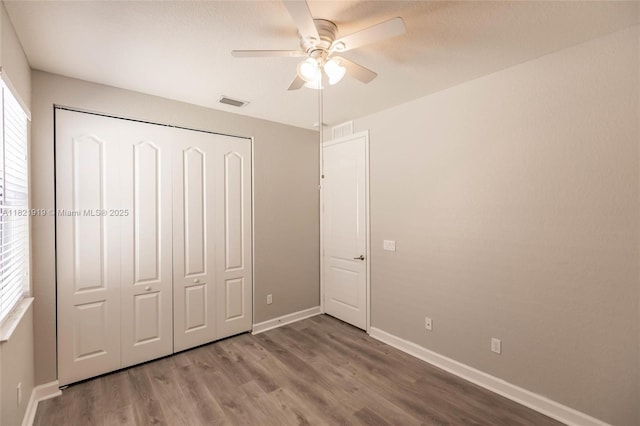 3809 Aspen Leaf Dr, Boynton Beach, FL 33436 - unfurnished bedroom with a closet, wood finished floors, and a ceiling fan