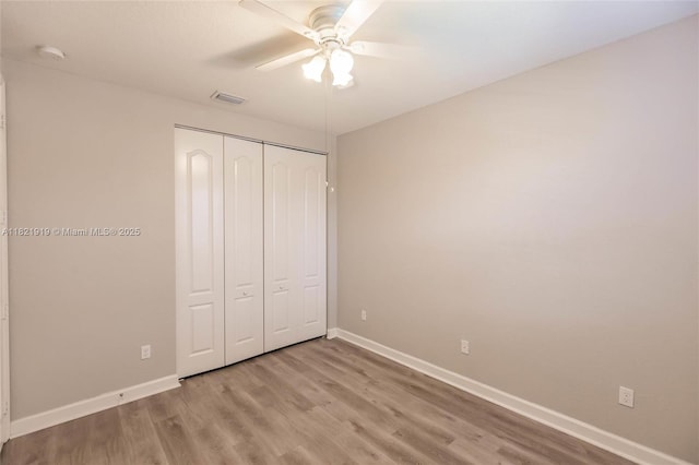 3809 Aspen Leaf Dr, Boynton Beach, FL 33436 - unfurnished bedroom with a closet, wood finished floors, and ceiling fan