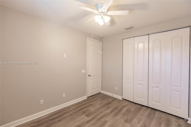 3809 Aspen Leaf Dr, Boynton Beach, FL 33436 - unfurnished bedroom featuring wood finished floors, a closet, and a ceiling fan