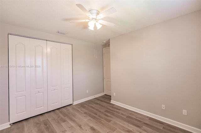 3809 Aspen Leaf Dr, Boynton Beach, FL 33436 - unfurnished bedroom featuring wood finished floors, a closet, and a ceiling fan