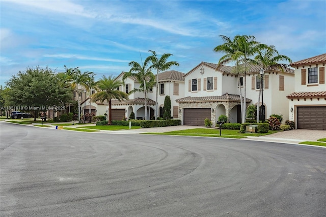 3809 Aspen Leaf Dr, Boynton Beach, FL 33436 - view of front of house with a residential view, driveway, a tile roof, and stucco siding