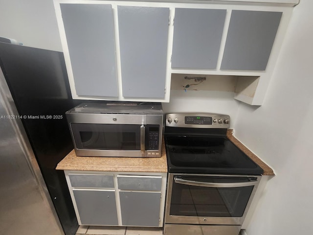 4150 NW 90th Ave Unit 203, Coral Springs, FL 33065 - kitchen with stainless steel appliances, light countertops, and gray cabinets