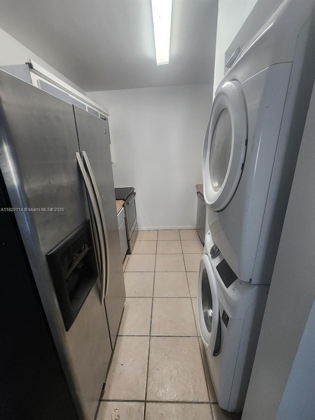 4150 NW 90th Ave Unit 203, Coral Springs, FL 33065 - washroom with estacked washer and dryer and light tile patterned flooring