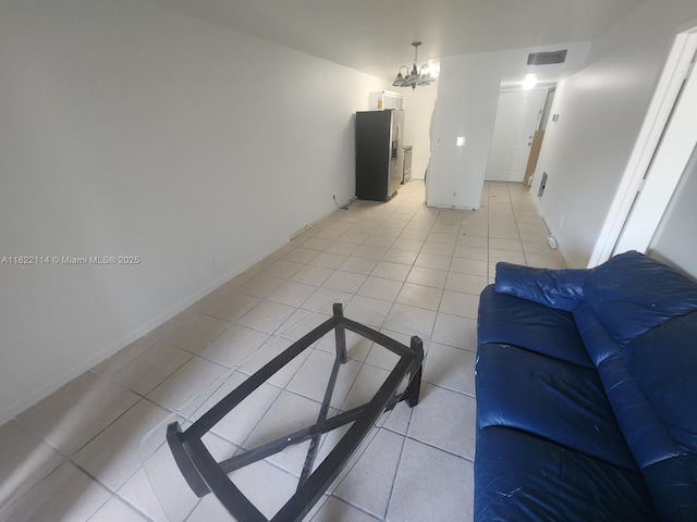 4150 NW 90th Ave Unit 203, Coral Springs, FL 33065 - unfurnished living room featuring light tile patterned floors and a chandelier