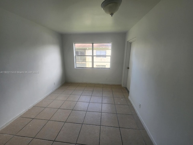 4150 NW 90th Ave Unit 203, Coral Springs, FL 33065 - empty room with light tile patterned floors and baseboards