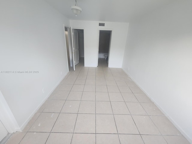 4150 NW 90th Ave Unit 203, Coral Springs, FL 33065 - empty room with light tile patterned floors and baseboards
