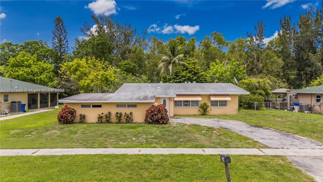886 Camellia Dr, Royal Palm Beach, FL 33411 - single story home featuring a front lawn, driveway, and stucco siding