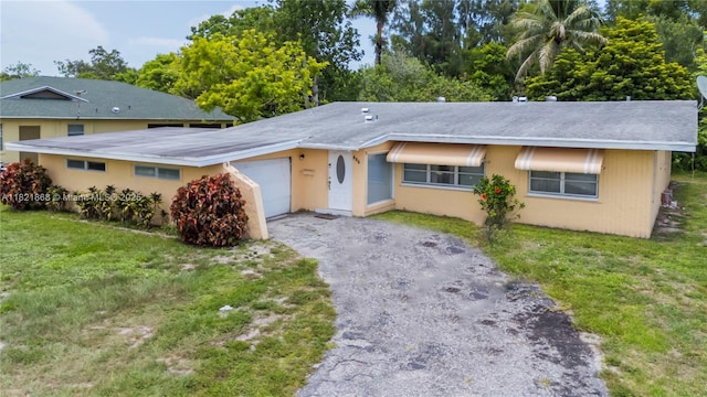 886 Camellia Dr, Royal Palm Beach, FL 33411 - ranch-style house with asphalt driveway, an attached garage, and a front lawn