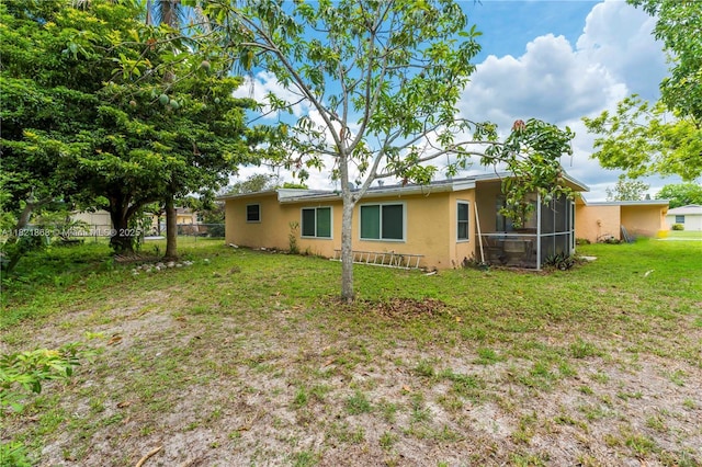 886 Camellia Dr, Royal Palm Beach, FL 33411 - back of house with stucco siding and a sunroom