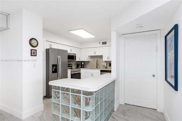 3530 Mystic Pointe Dr Unit 2108, Aventura, FL 33180 - kitchen with stainless steel appliances, light marble finish floors, white cabinets, light countertops, and decorative backsplash