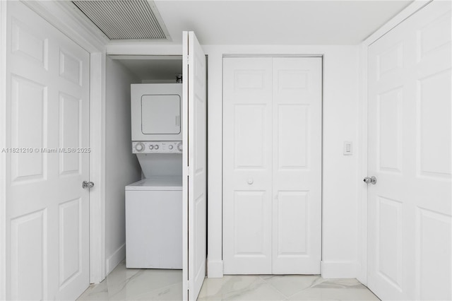3530 Mystic Pointe Dr Unit 2108, Aventura, FL 33180 - laundry room with stacked washing machine and dryer and light marble finish floors