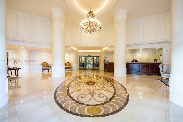 3530 Mystic Pointe Dr Unit 2108, Aventura, FL 33180 - lobby featuring a towering ceiling, a decorative wall, and crown molding