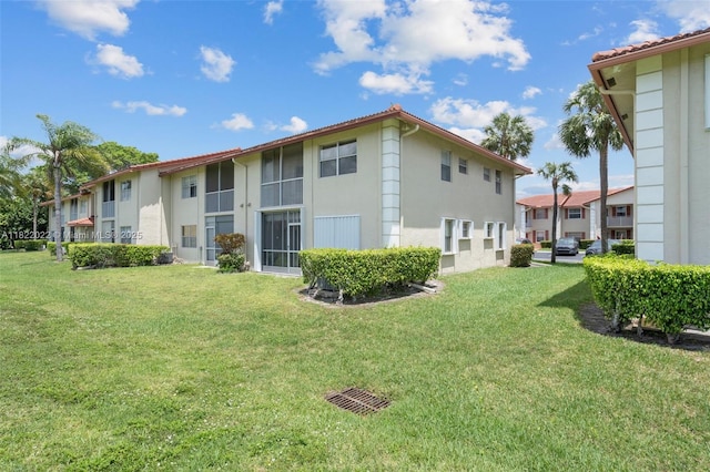 3001 Holiday Springs Blvd Unit 201, Margate, FL 33063 - back of house with stucco siding, a yard, and a tiled roof