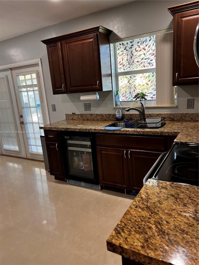 7151 Pershing St, Hollywood, FL 33024 - kitchen featuring wine cooler, dark brown cabinetry, dark countertops, and light tile patterned floors