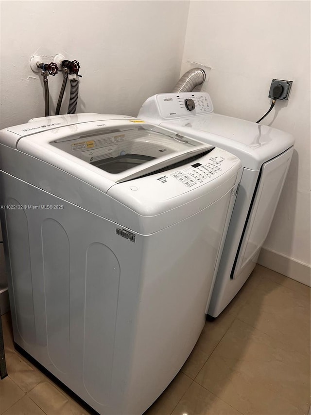 7151 Pershing St, Hollywood, FL 33024 - washroom featuring washer and dryer and light tile patterned floors