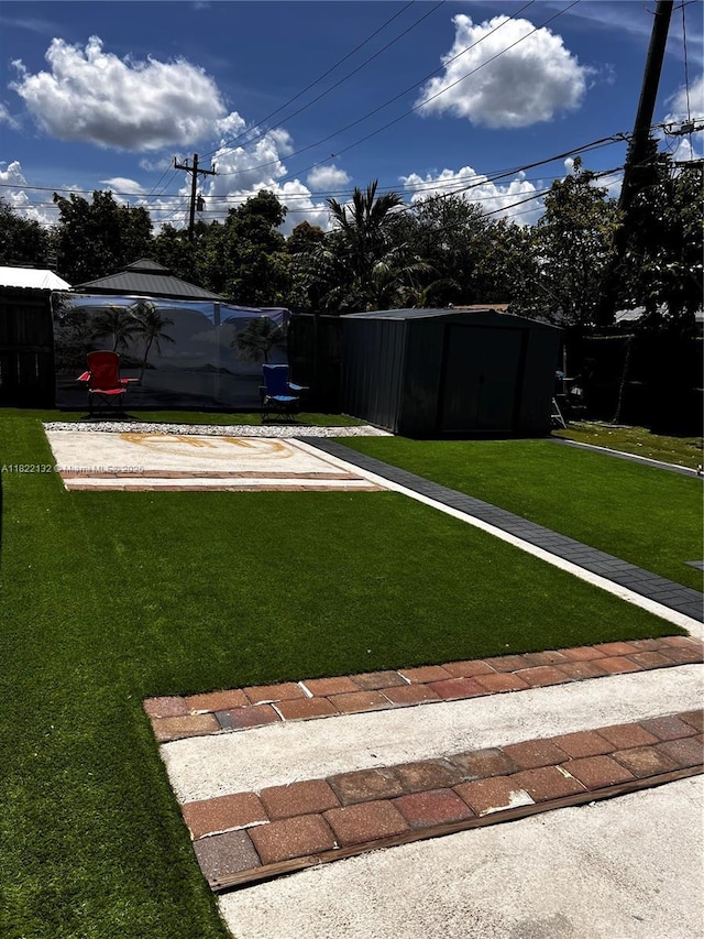 7151 Pershing St, Hollywood, FL 33024 - view of green lawn with a storage unit and a bocce ball area