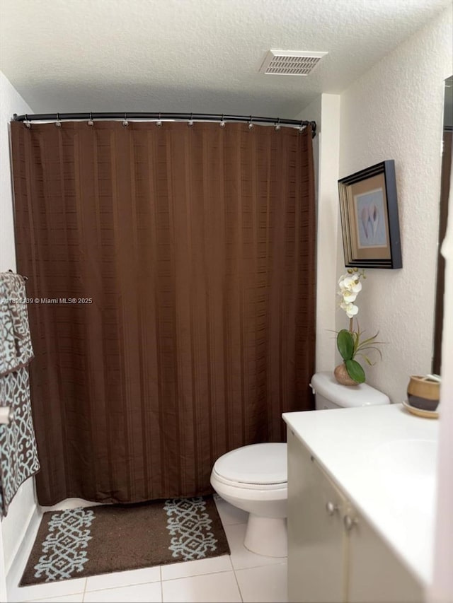 15400 SW 284th St Unit 1308, Homestead, FL 33033 - bathroom with vanity, tile patterned floors, a textured ceiling, a textured wall, and a shower with shower curtain
