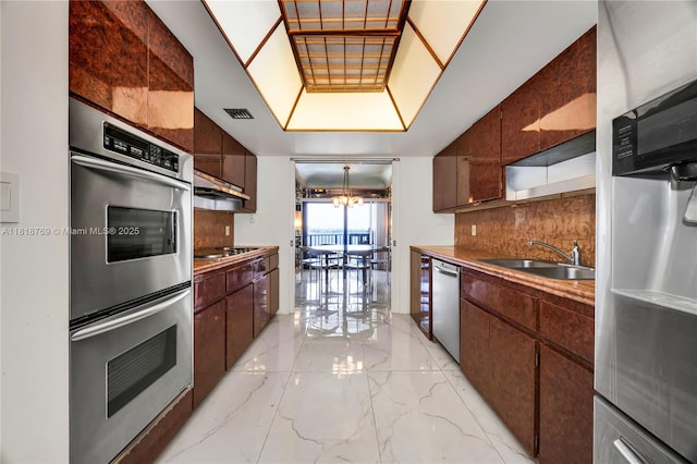 1800 NE 114th St Unit 1103, Miami, FL 33181 - kitchen with stainless steel appliances, light marble finish floors, open shelves, backsplash, and a chandelier