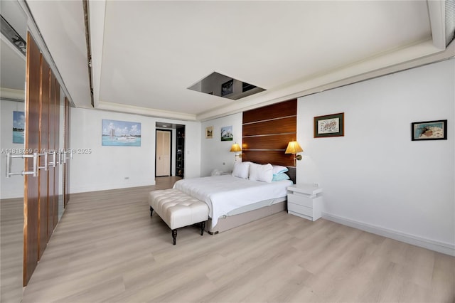 1800 NE 114th St Unit 1103, Miami, FL 33181 - bedroom featuring light wood-type flooring and a tray ceiling