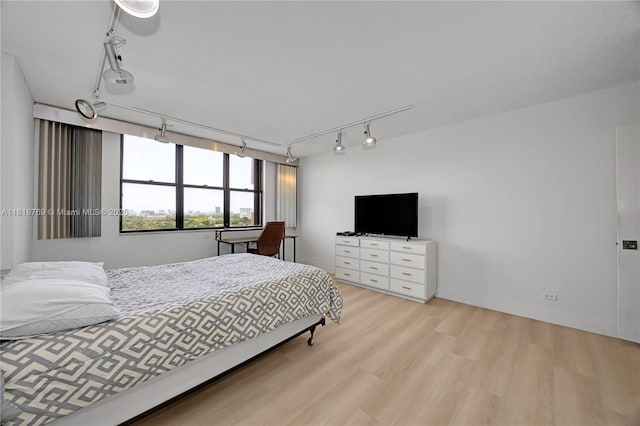 1800 NE 114th St Unit 1103, Miami, FL 33181 - bedroom featuring rail lighting and light wood-type flooring